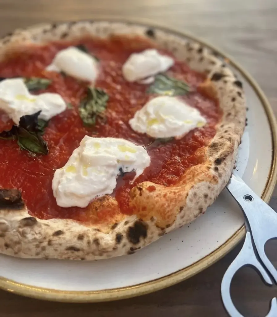pizza on plate with scissors served at a16 in san francisco