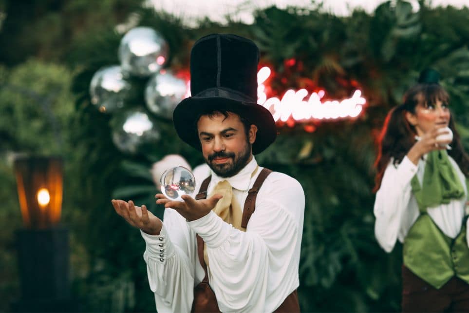 magician looking at glass ball during corporate talent show
