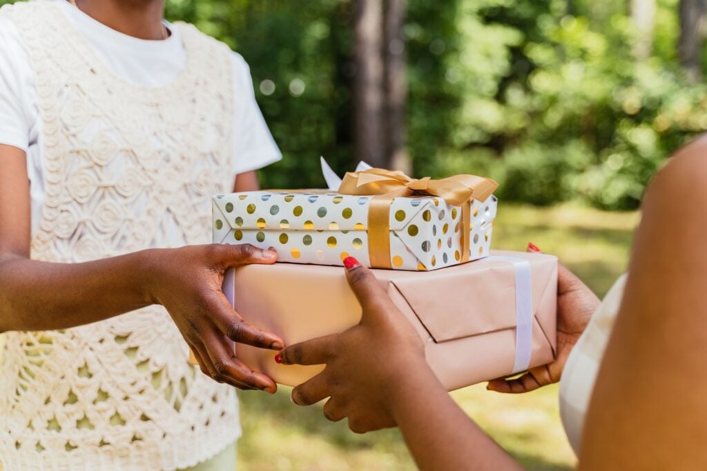 Two people exchange gifts