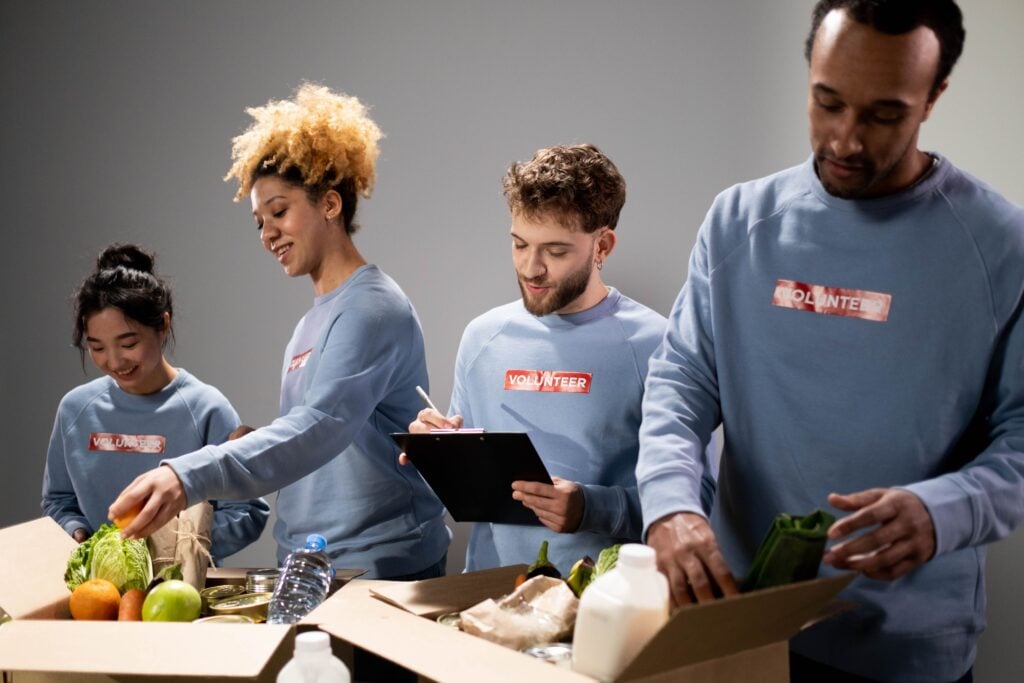 Team members package produce for a charity drive