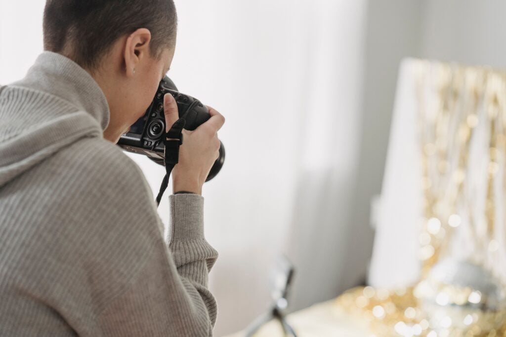 A photographer peers through their camera