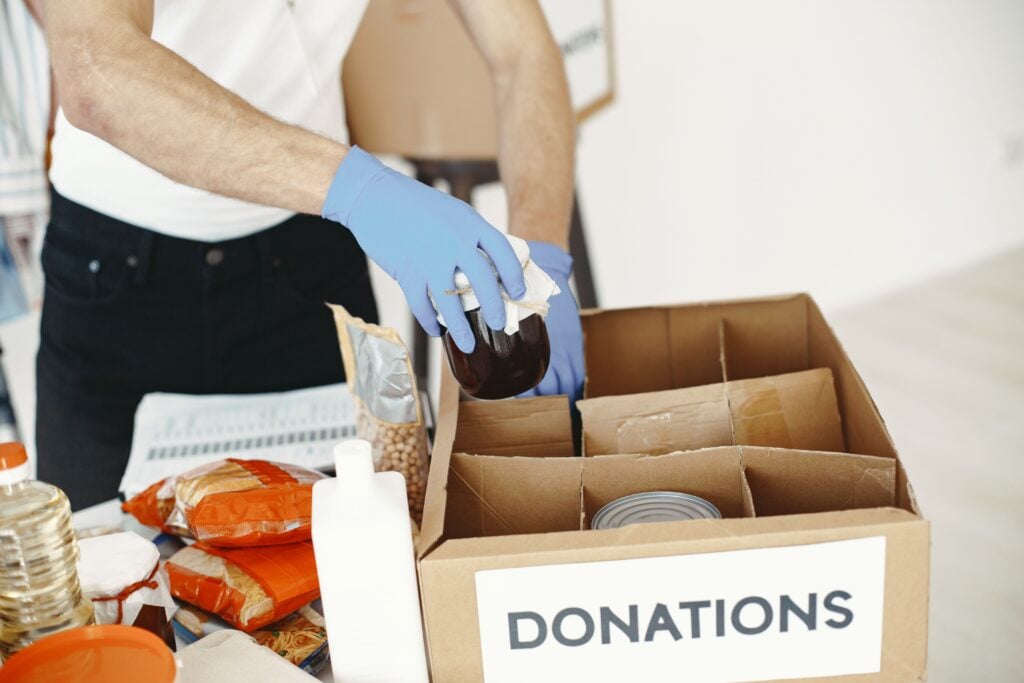 Team members pack food for donations