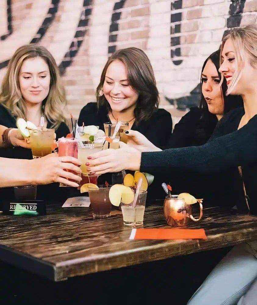 group of women toasting cocktails at parlay in chicago's river north