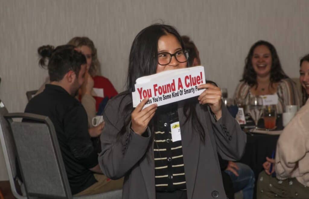 A guest gets a clue at a Dinner Detective Murder Mystery Dinner