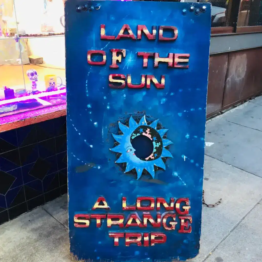 A sign with an outer space design for Land of the Sun