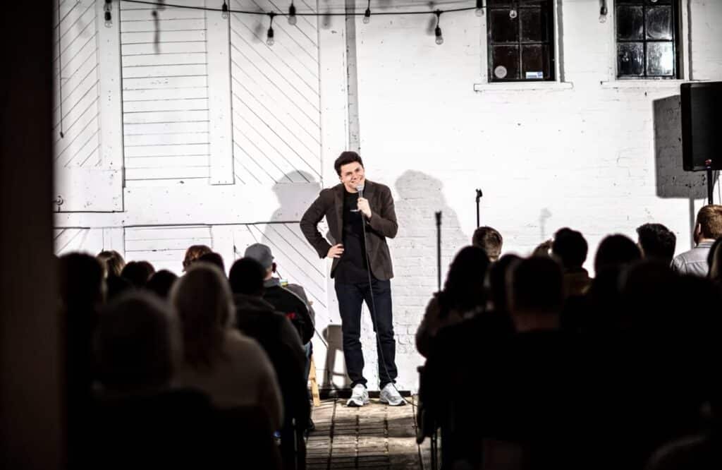 A stand up takes the stage at Don't Tell Comedy in Denver