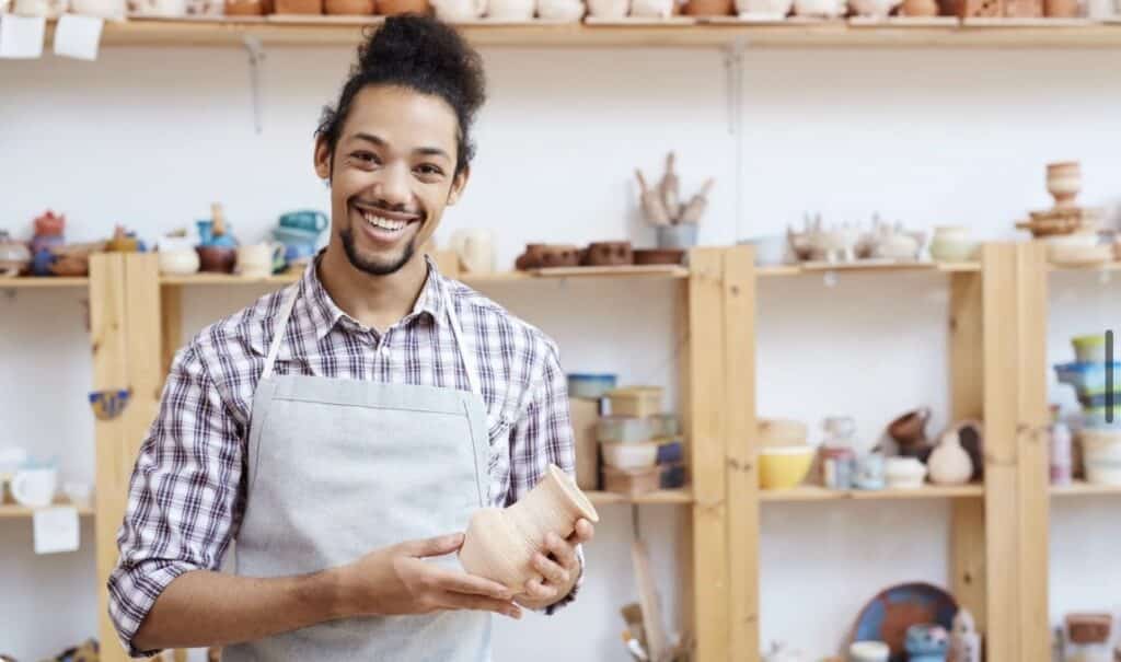 A man shows off his creation at Pottery Studio NYC