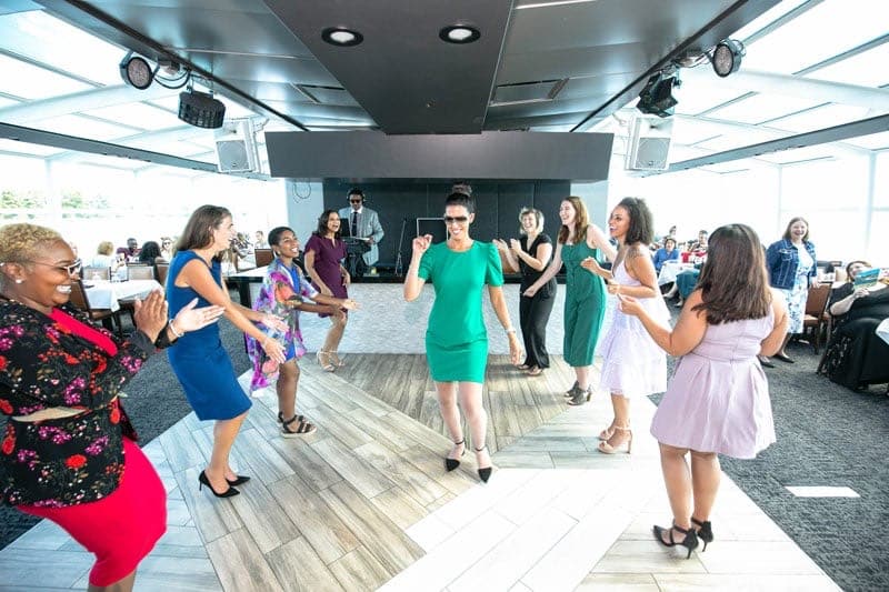 Team members shake a leg on the dance floor on a city experience cruise in San Francisco