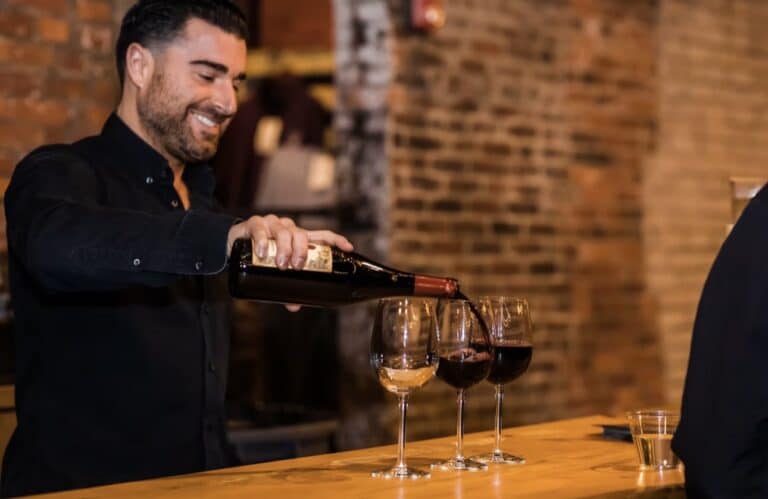 A sommelier pours glasses of wine at Boston Winery