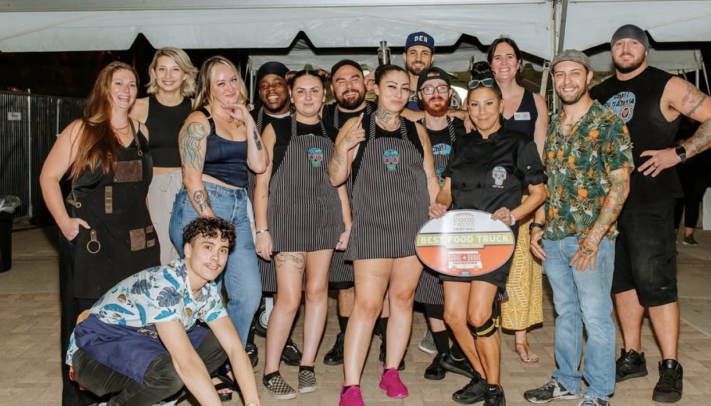 Coworkers pose after a successful Denver Food and Wine Festival