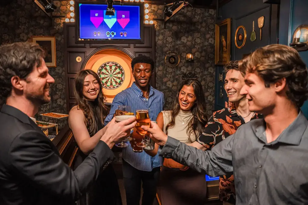 Coworkers cheers after a round at Fight Club Darts Denver