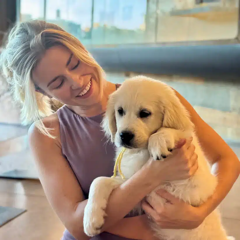Girl plays with Puppy at Puppy Yoga in New York