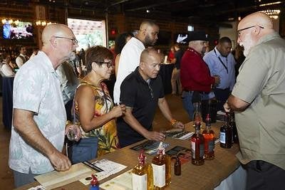 A team tastes liquor at an SF food festival
