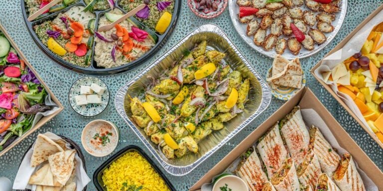 Platters of flavorful Mediterranean cuisine adorn a table at an event catered by La Mediterranee