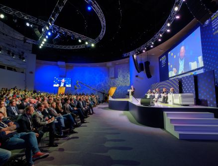 A panel of speakers sits onstage at an Event Solutions corporate event