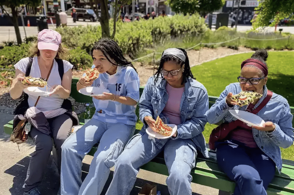 A group on an SF Secret Food Tour enjoys pizza slices