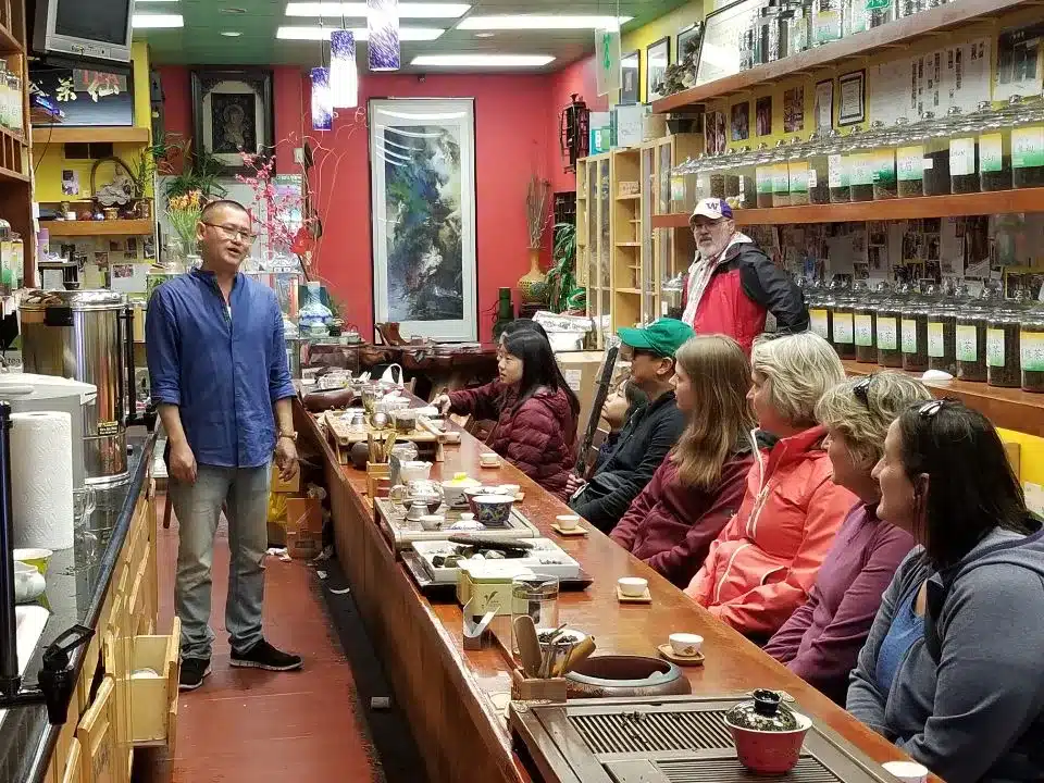 Guests on a Local Tastes of the City Food Tour in SF sit down for tea in Chinatown