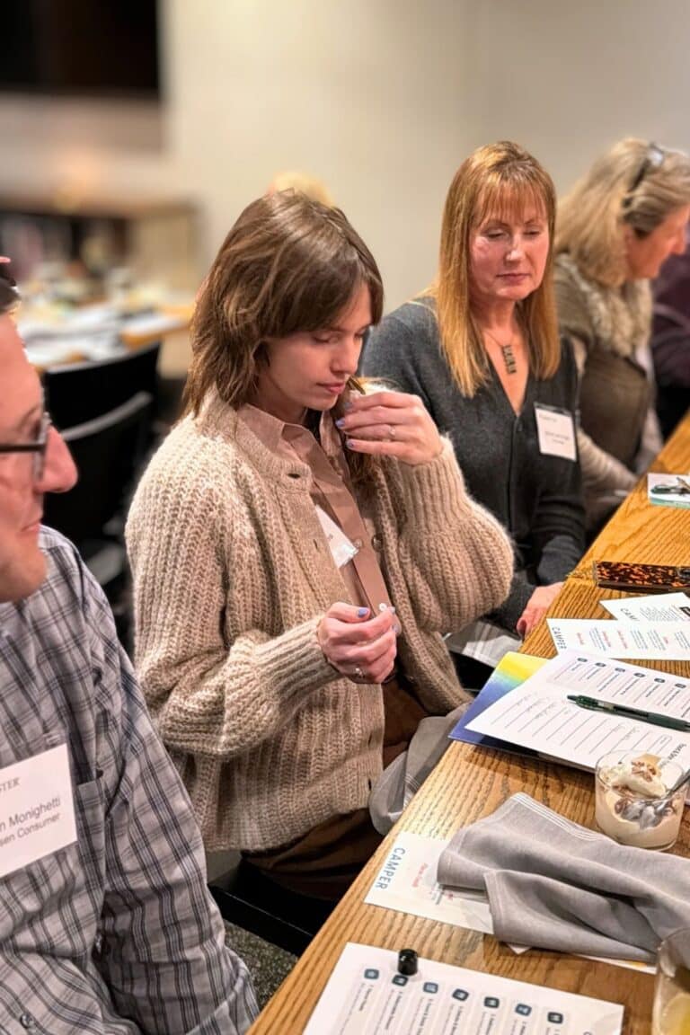 woman smelling bottle during smell like a somm activity with avital experiences