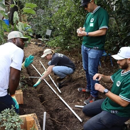 Team members get their hands in the dirt at the East Palo Alto Community Garden