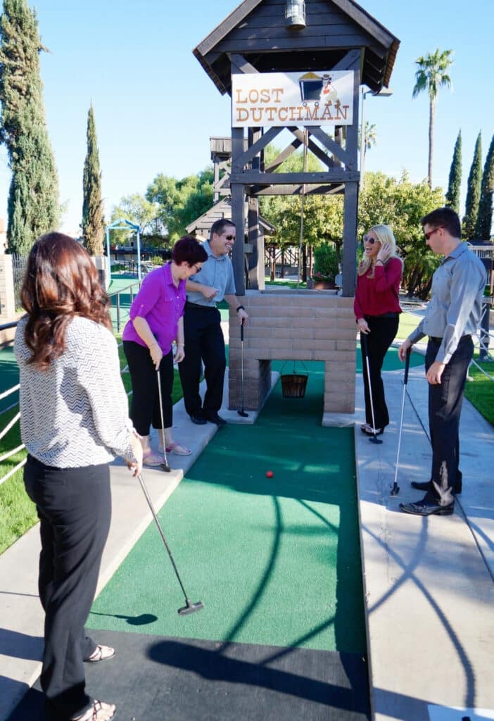 Adults chart out a difficult hole at Golfland Mini Golf