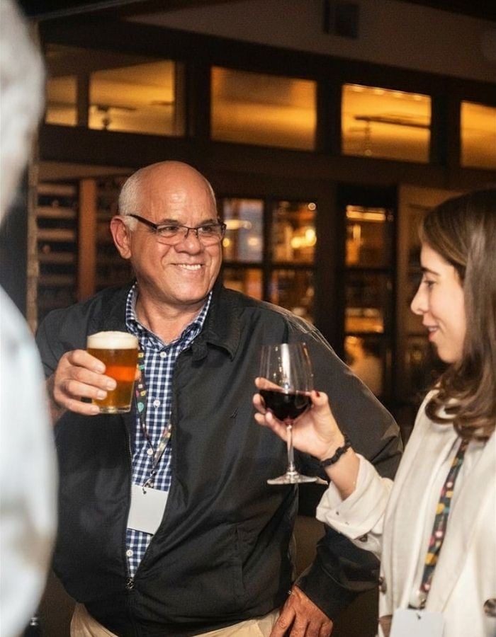 man and woman with beer and wine during interactive mingling hour in san francisco
