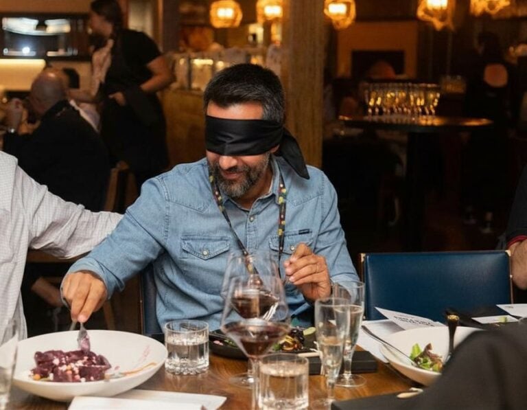 man eating dining in the dark style during sf sensory dinner