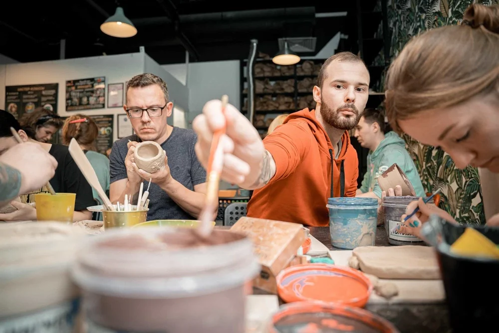 Team members paint their pots at Pottery Studio 1 in Chicago