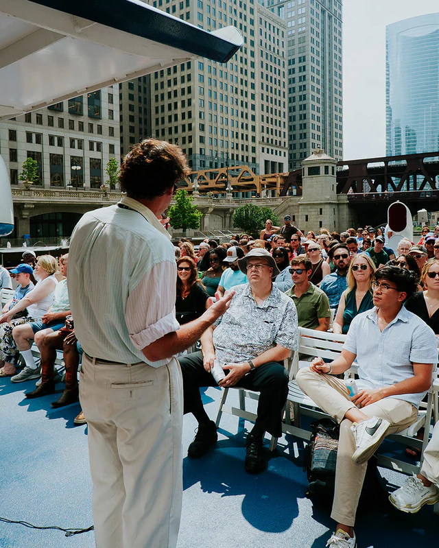 People are emraptured on an architecture boat tour of Chicago