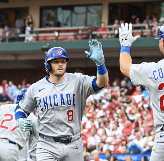 Cubs teammates high five after a home run