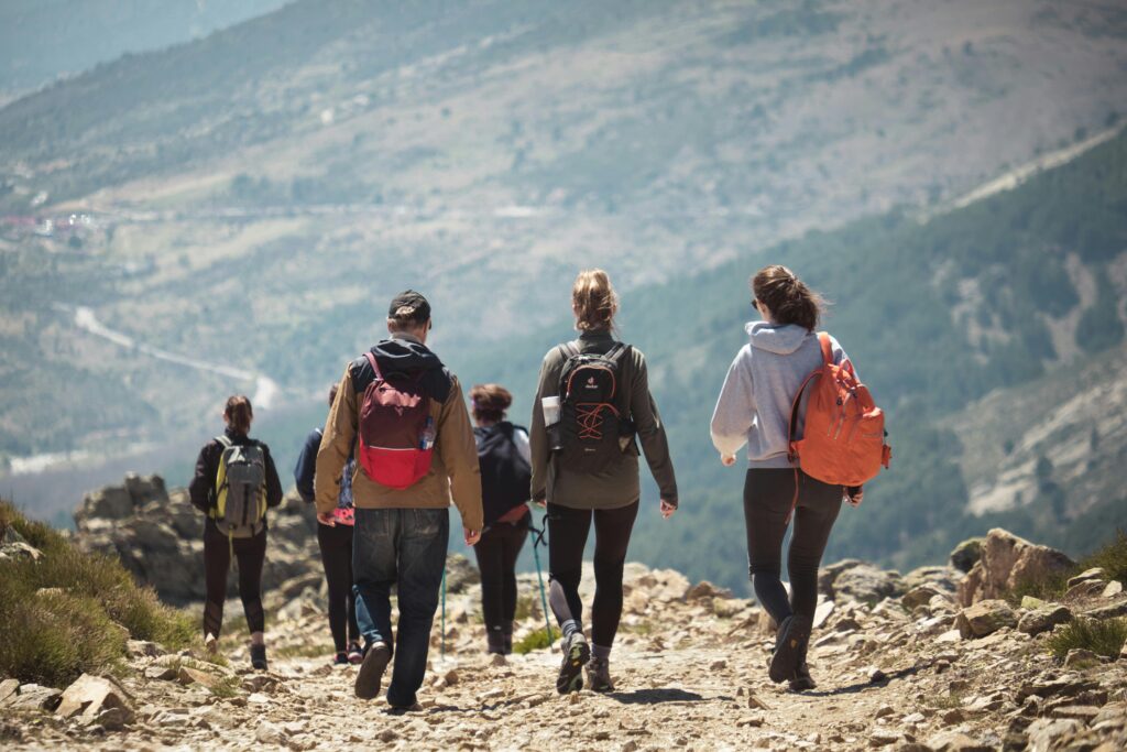 A team takes a scenic hike together on a mountain