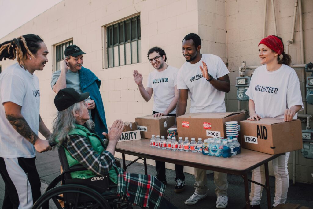 Team members help out in their community by handing out water and provisions