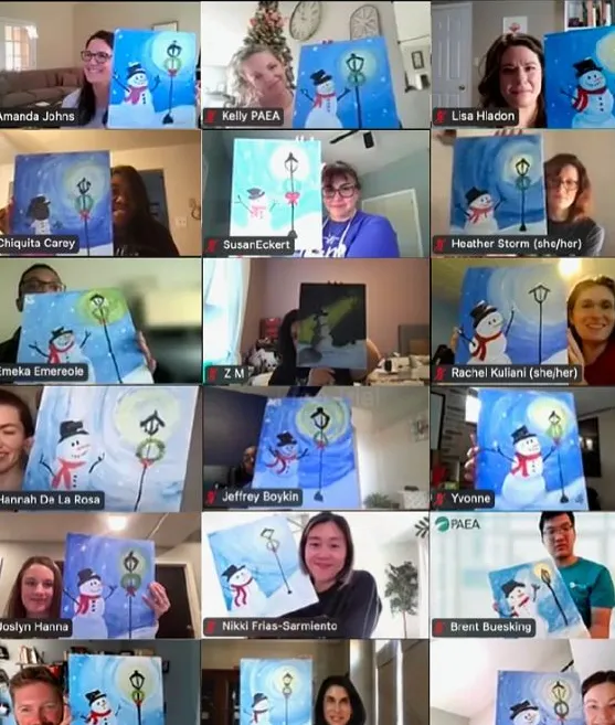 Team members compare their art at a virtual paint and sip experience