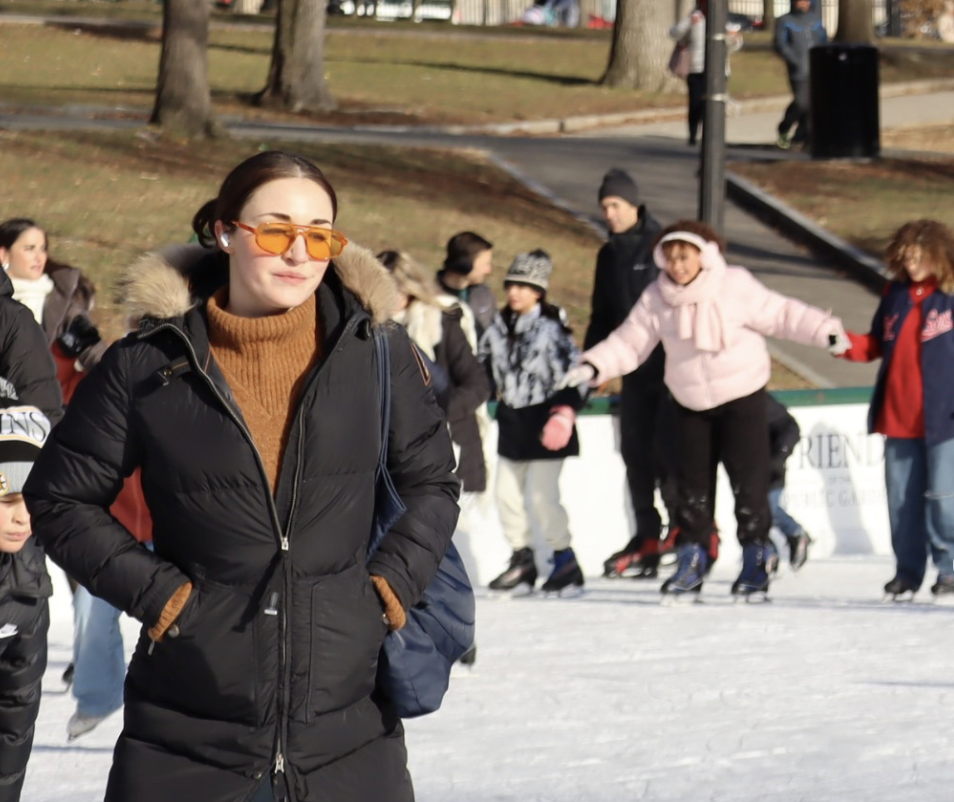 A team enjoys ice skating at the Frog Pond in Boston