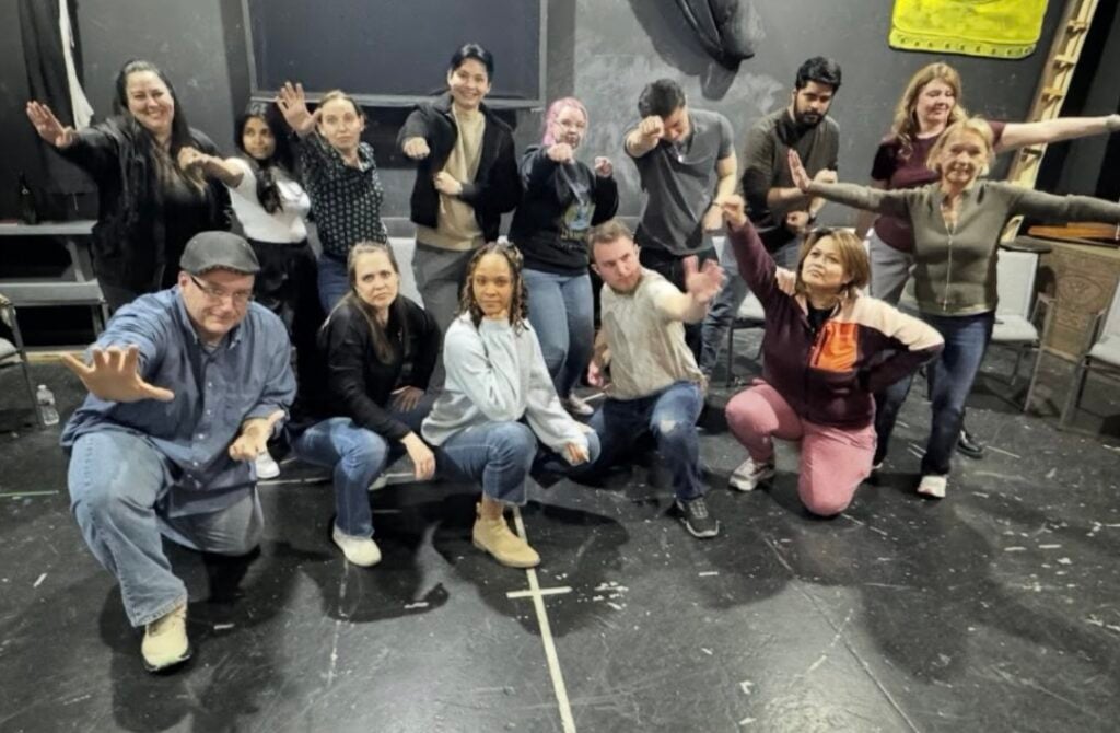 Coworkers strike goofy poses at a Vegas Improv Power class