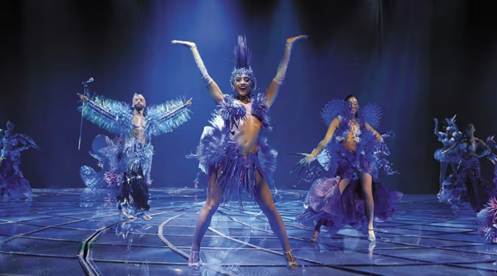 Performers in magnificient blue costumes dance at Awakening Vegas