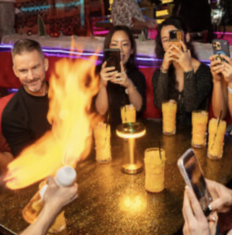 A tour guide lights up oil to impress guests taking pictures on a Lip Smacking Foodie Tour