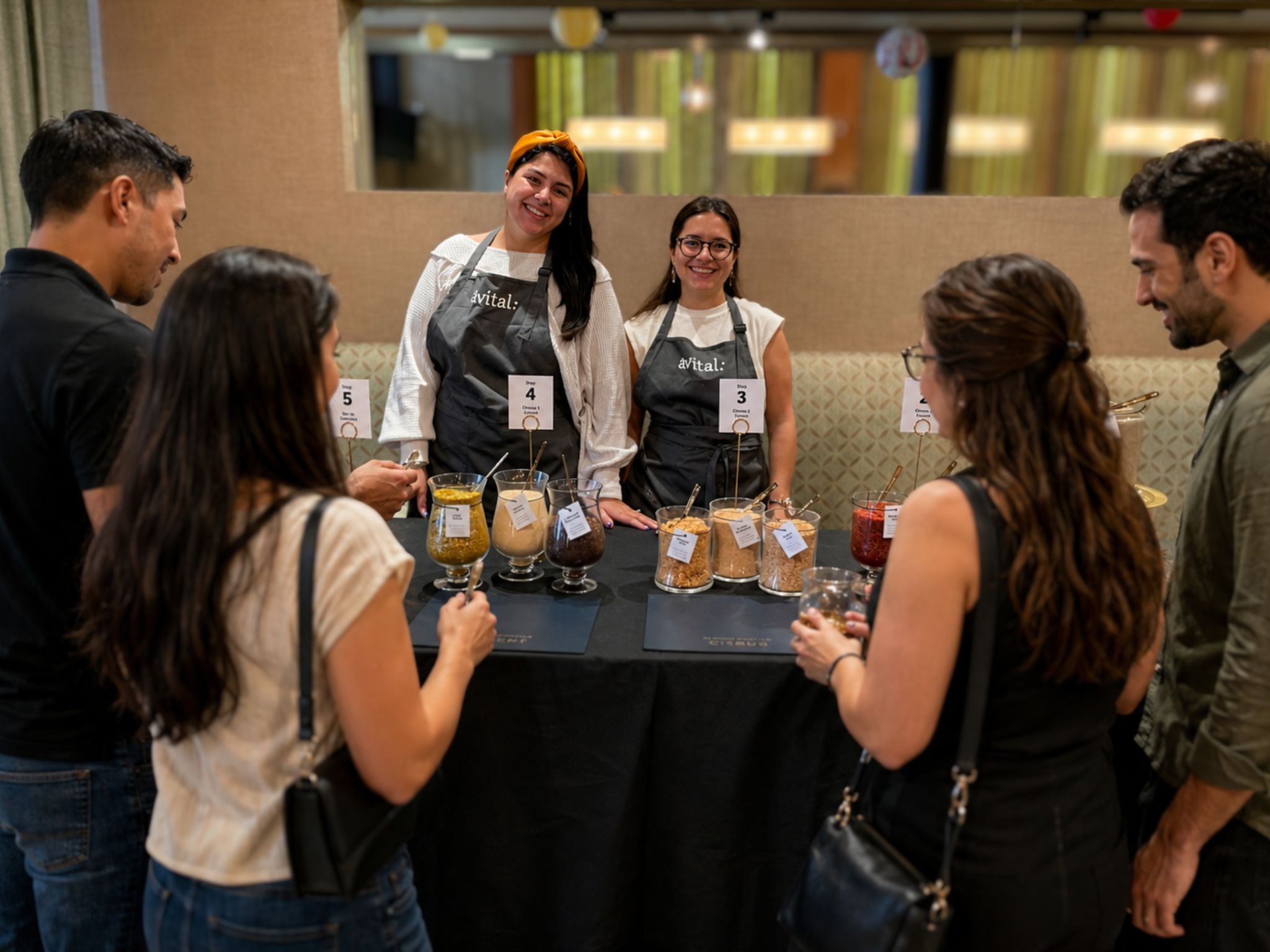 avital hosts engaging with guests at interactive foodie stations