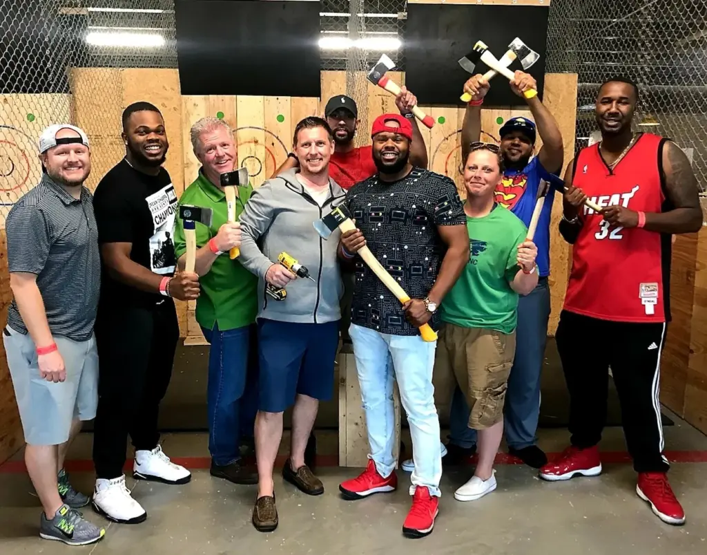 Team members pose in front of the targets at Urban Axes in Boston