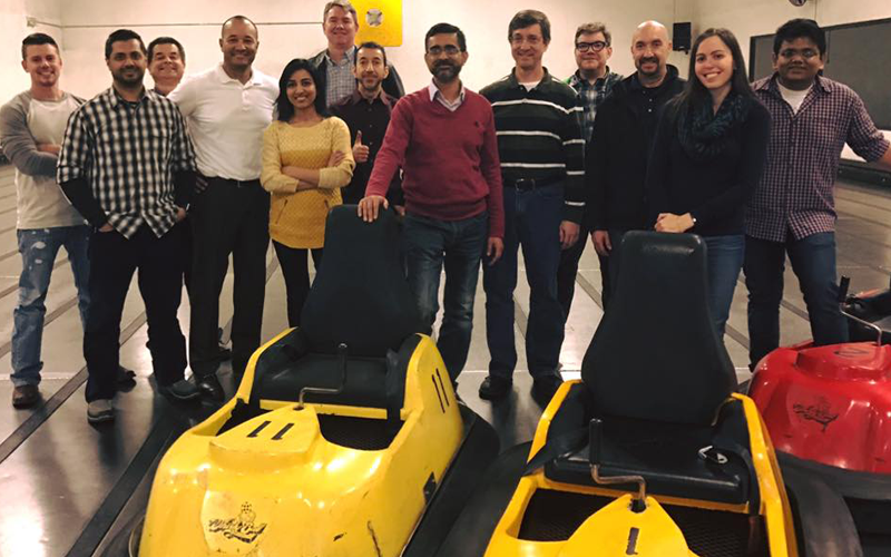Team members pose in front of the bumper cards at Whirlyball