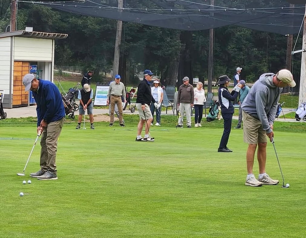 Multiple people put on the green at the Deep Cliff Golf Course
