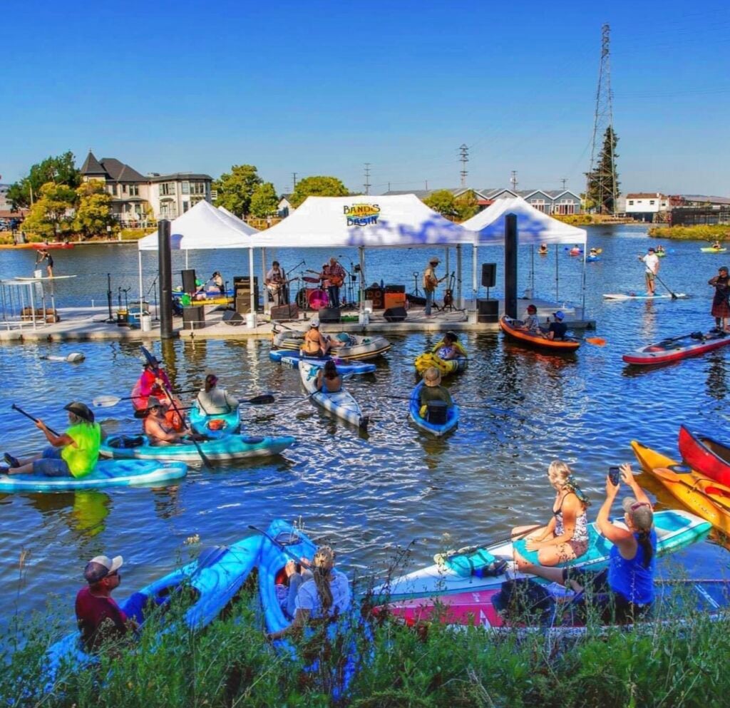 The lake is full of people on colorful kayaks
