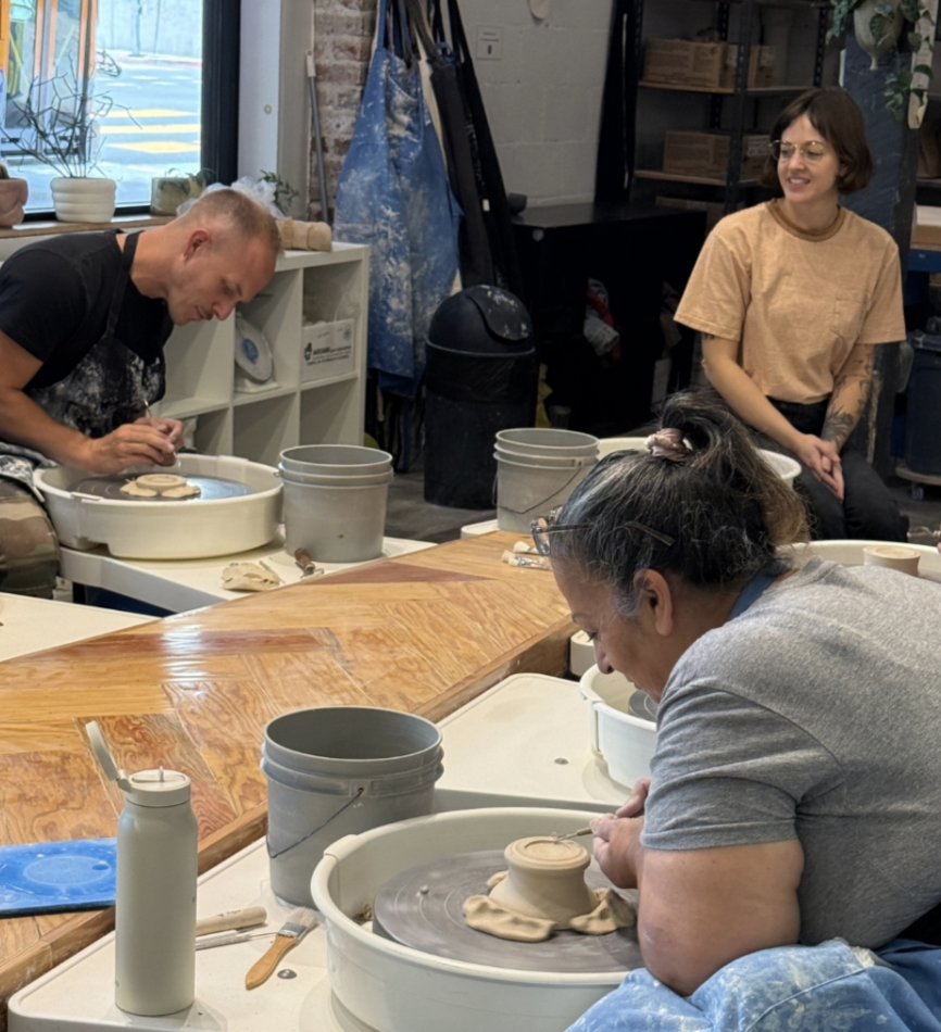 Team members enjoy a pottery throwing class at Throw Clay LA
