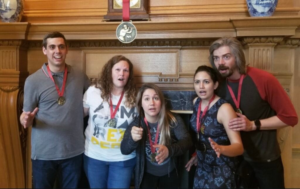 Team members strike a pose on a scavenger hunt at the National Gallery