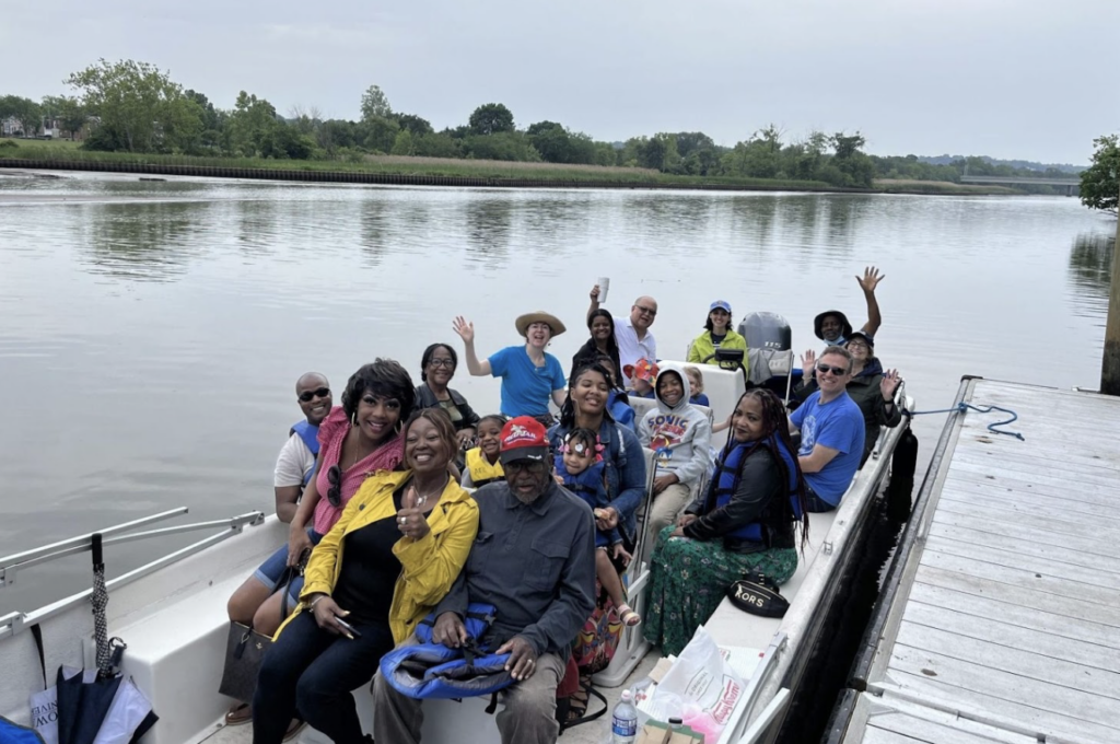 Team members wave aboard a River Explorer