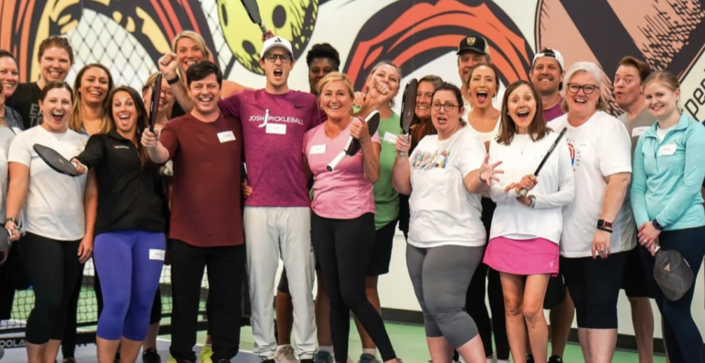 Team members pose after a round of pickleball at Experience Kraken