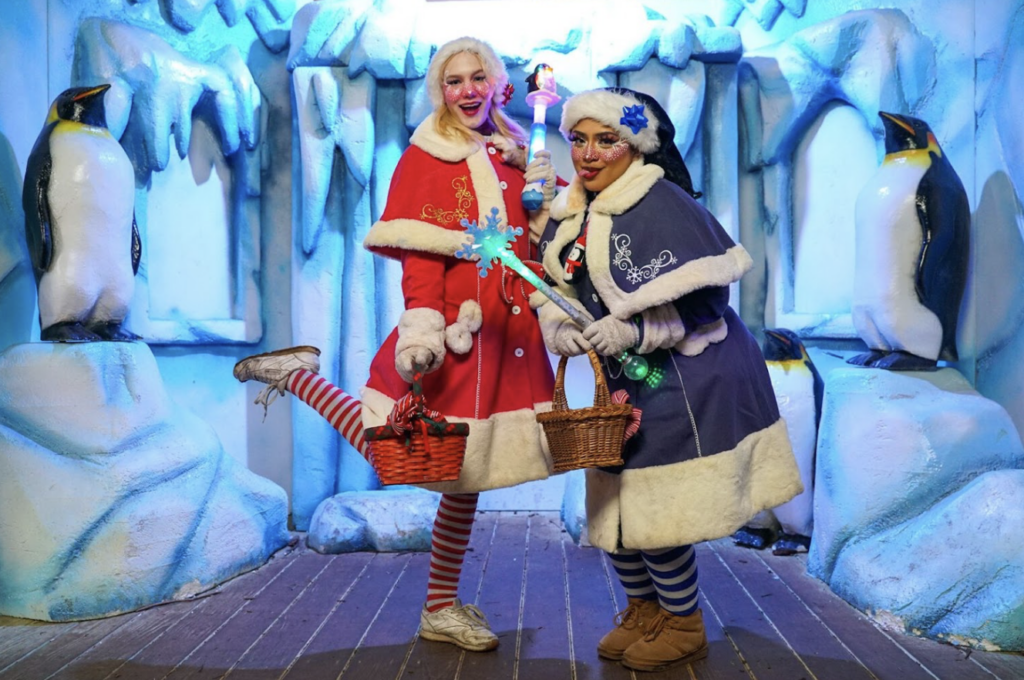 Two women dress up as santas helpers at the Winter City Lights Show