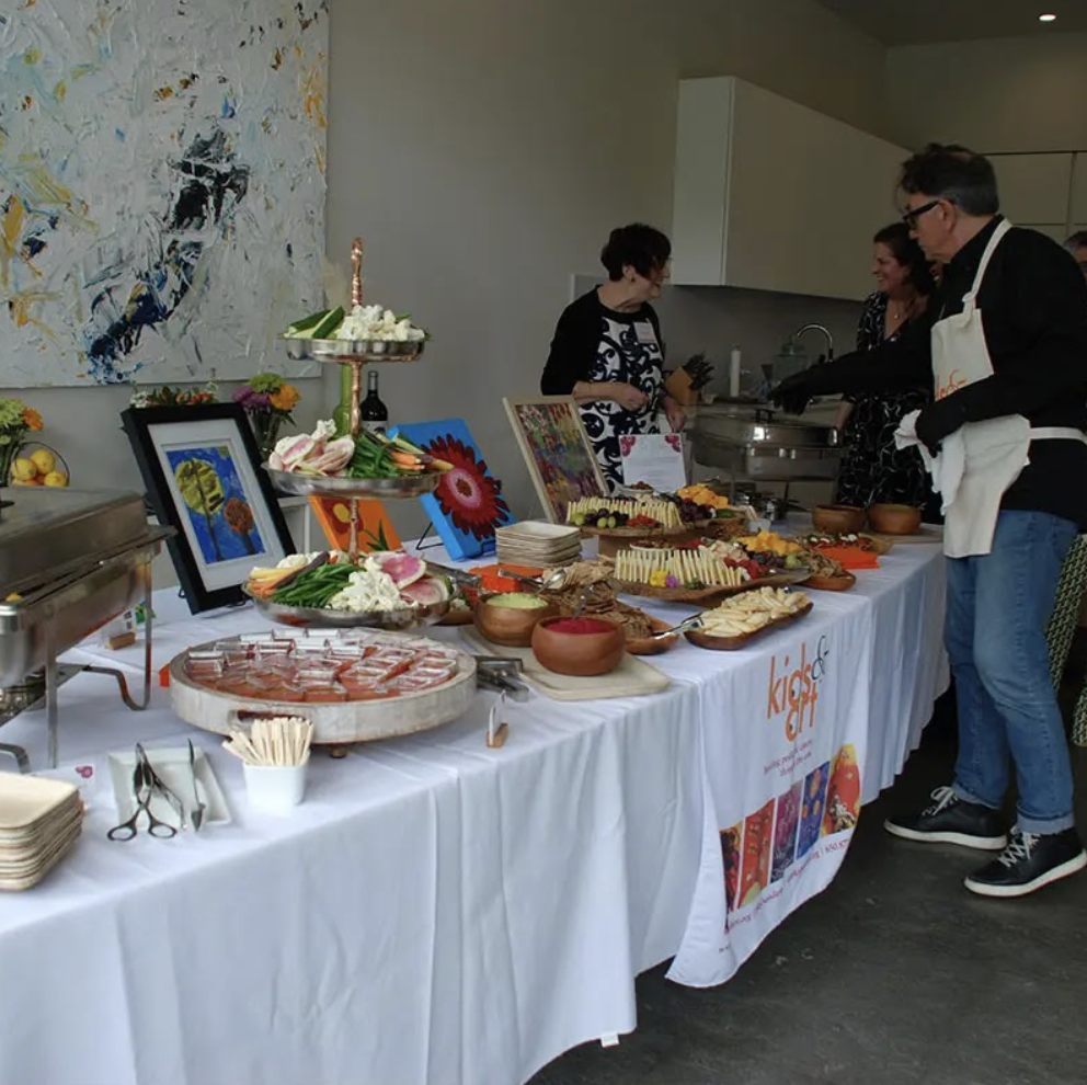 Volunteers set up a table for a Kids and Art event