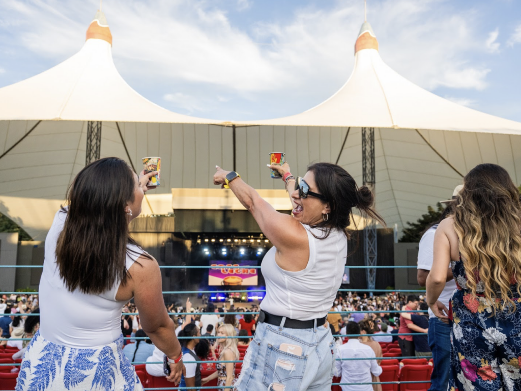 Two friends dance as a band plays at the Shoreline Amphitheater