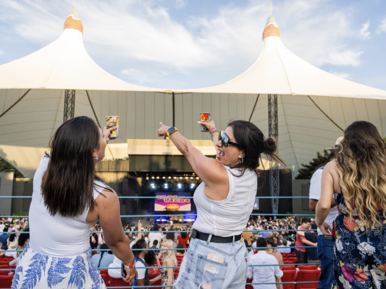 Two friends dance as a band plays at the Shoreline Amphitheater