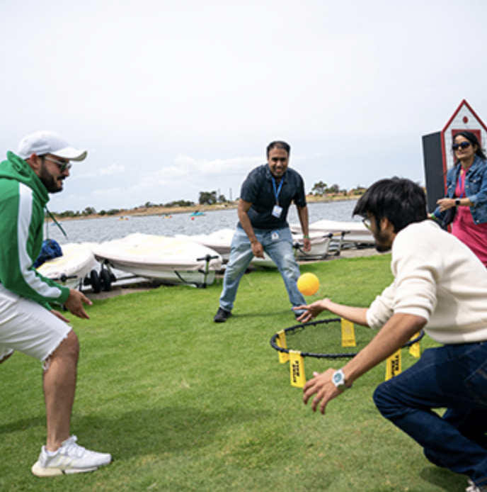 Three friends try and keep a ball up as they play at the Shoreline Lake